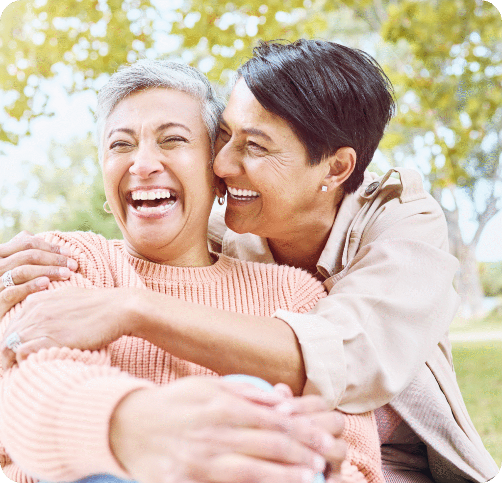 Two women smiling and hugging, symbolizing the simple, elegant solution CARLEN offers for complex FMR treatment.